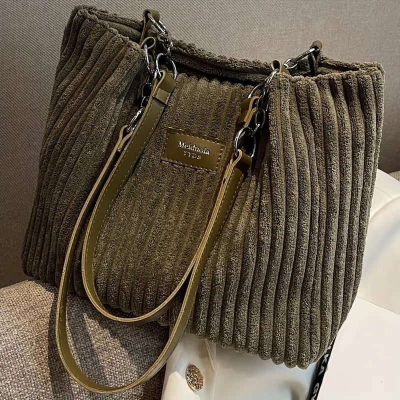Bolso de pana Veyro Madrid con asas dobles, estilo elegante y detalles en la superficie, en color neutro.