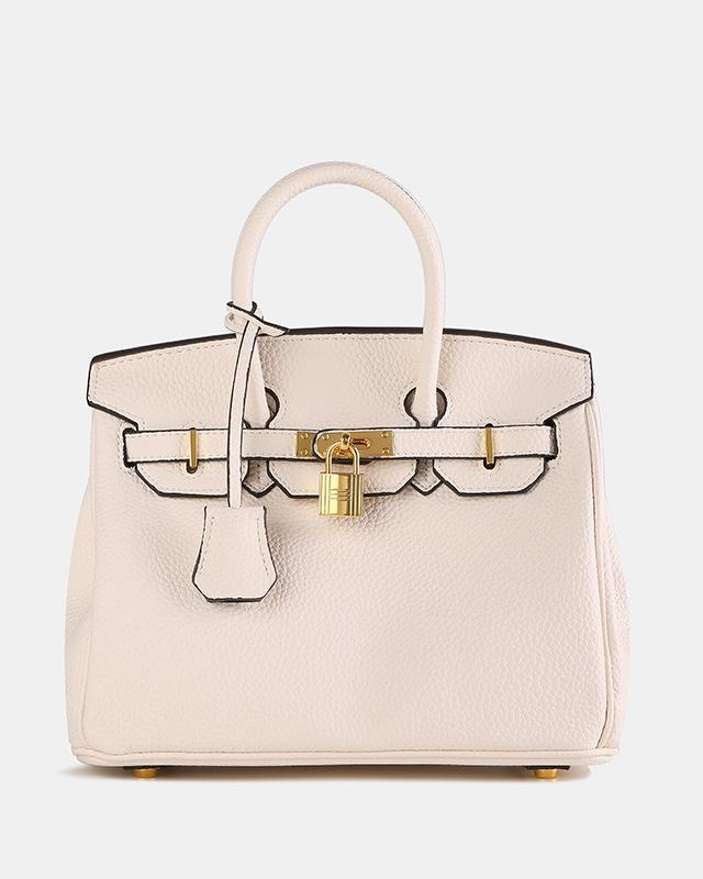 Bolso de cuero MILA de Veyro Madrid con diseño elegante y asa larga, en color marrón oscuro sobre fondo neutro.