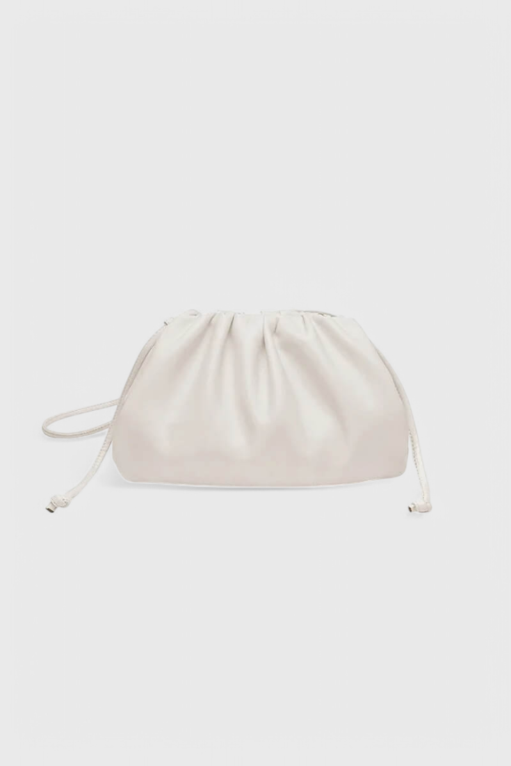 Bolso cruzado Dalila de Veyro Madrid, en color beige con detalles en negro y correa ajustable, en un fondo neutro.