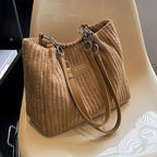 Bolso de pana Veyro Madrid con asas dobles, diseño elegante y práctico en tonos neutros.